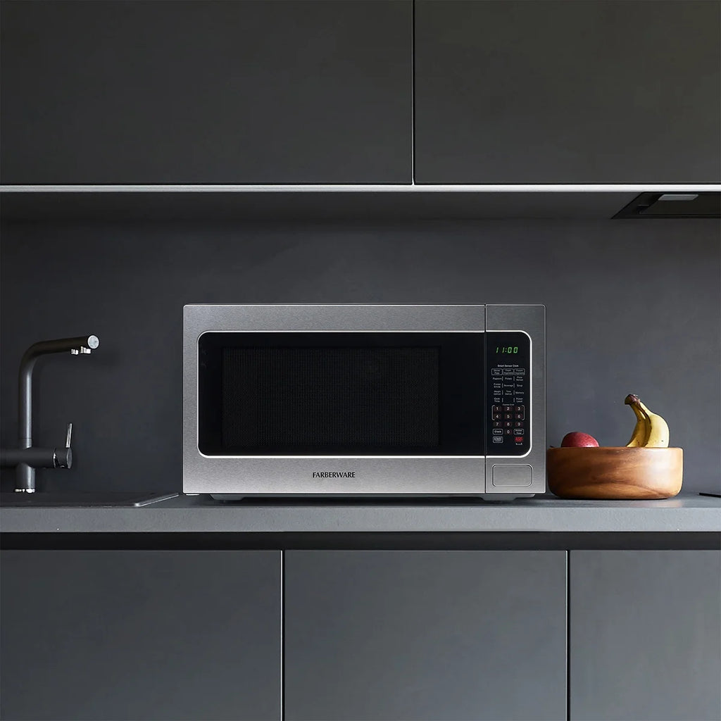 Farberware Countertop Microwave Ov 1100 Watts. 2.2 cu ft - Smart Sensor With LED Lighting and Child Lock - Perfect for Apartments and Dorms - Easy Clean Black Interior. Stainless Steel